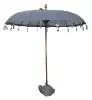 Product image 1 of the product “Bali umbrella , dark grey 2 with wooden coins and gold leaves hanging around the edge. Approx. 230cm dia. and 250cm height ”